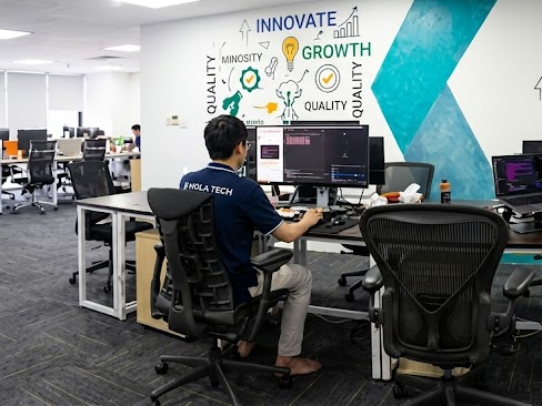 An engineer at his desk by the Innovate and Growth wall